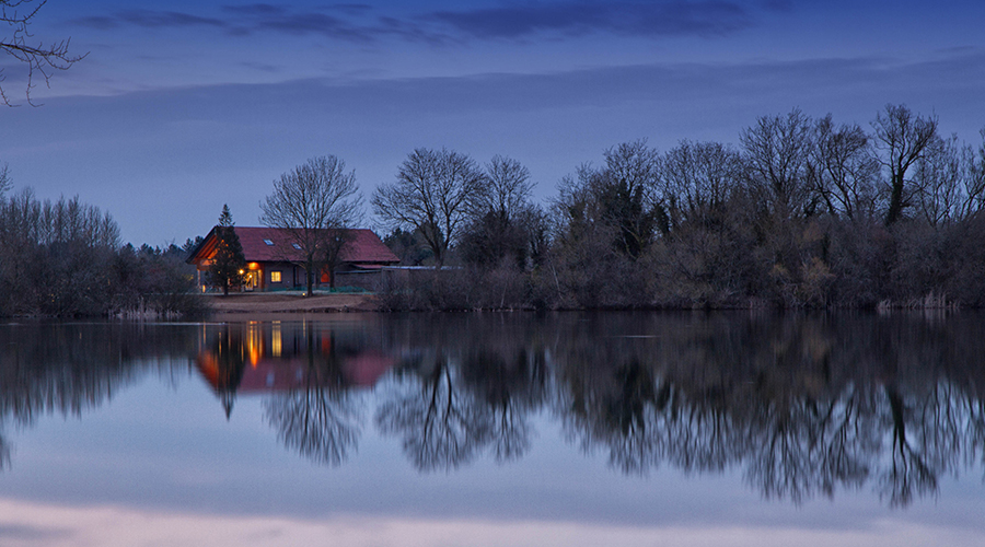Log cabin by a lake at Loghouse Holidays